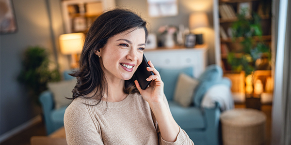 Woman talking on phone in living room