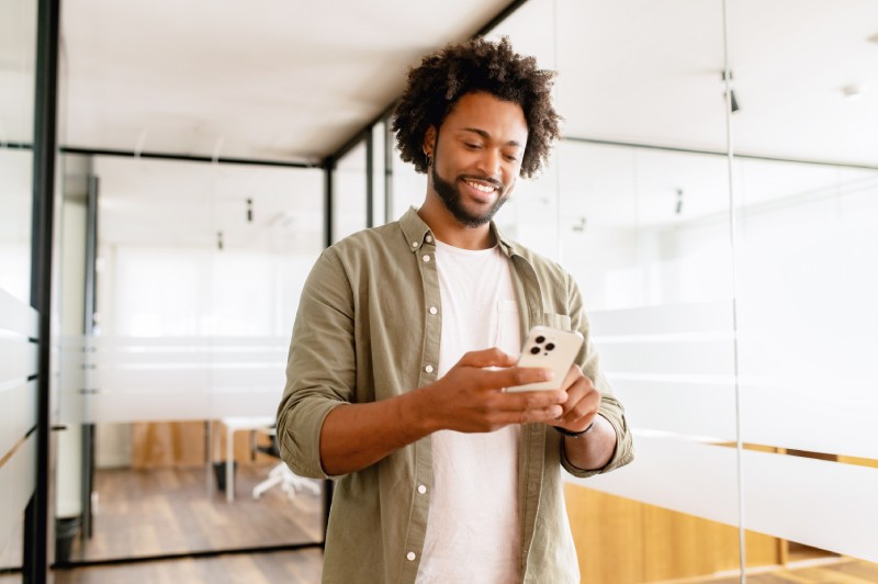 A man uses a cellphone to check his Home Equity Loan balance
