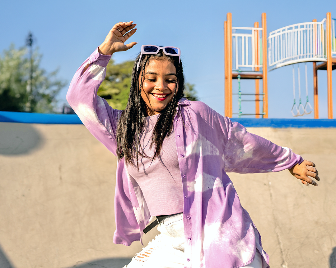 Happy teenaged girl having fun and dancing